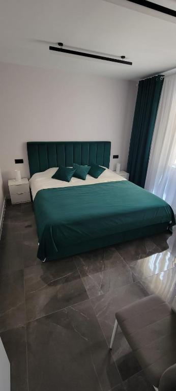 a bedroom with a large green bed in a room at Sol Del Mar in Benicarló