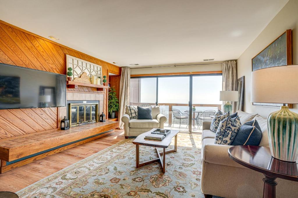 a living room with a couch and a fireplace at Pool Access: Scenic Condo in Wintergreen Resort! in Mount Torry Furnace