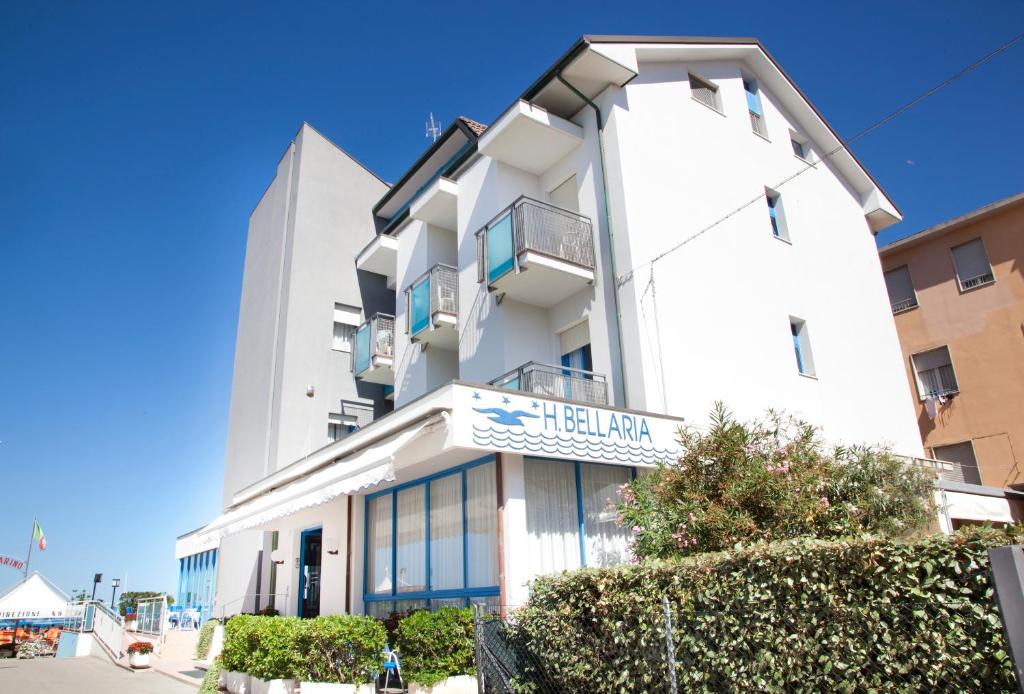 a tall white building with a sign on it at Hotel Bellaria in Bellaria-Igea Marina