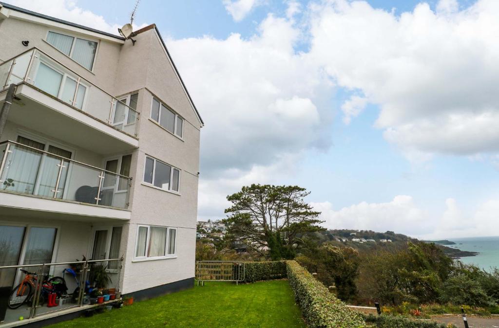 a house with a grassy yard next to a building at Godrevy View in St Ives