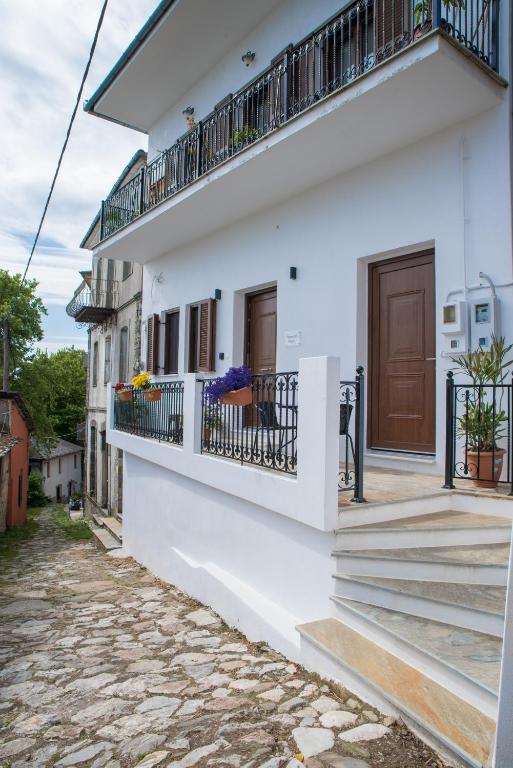 a white house with balconies on a street at Veronica's House in Zagora