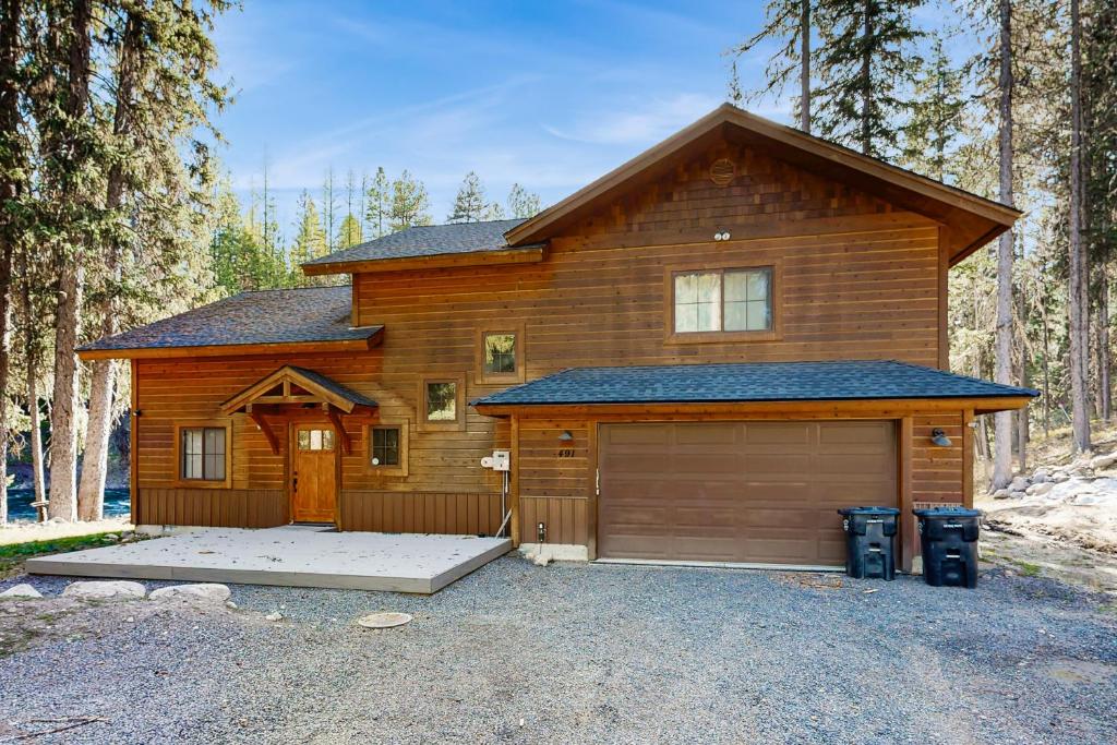 a large wooden house with a large garage at Rivers Edge Retreat in McCall
