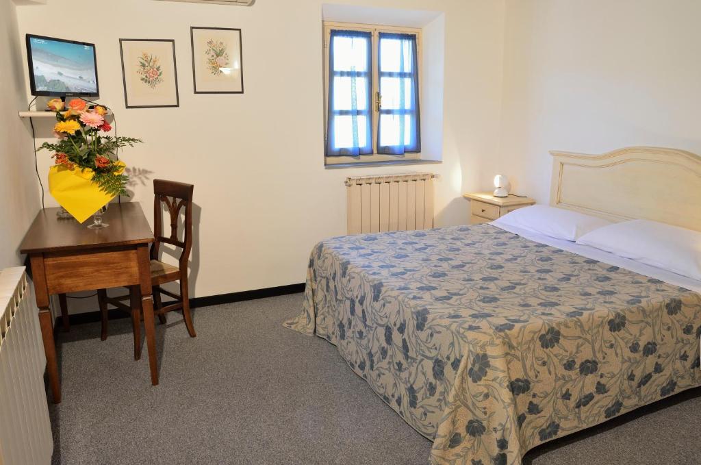 Postel nebo postele na pokoji v ubytování Hotel Calzaiolo
