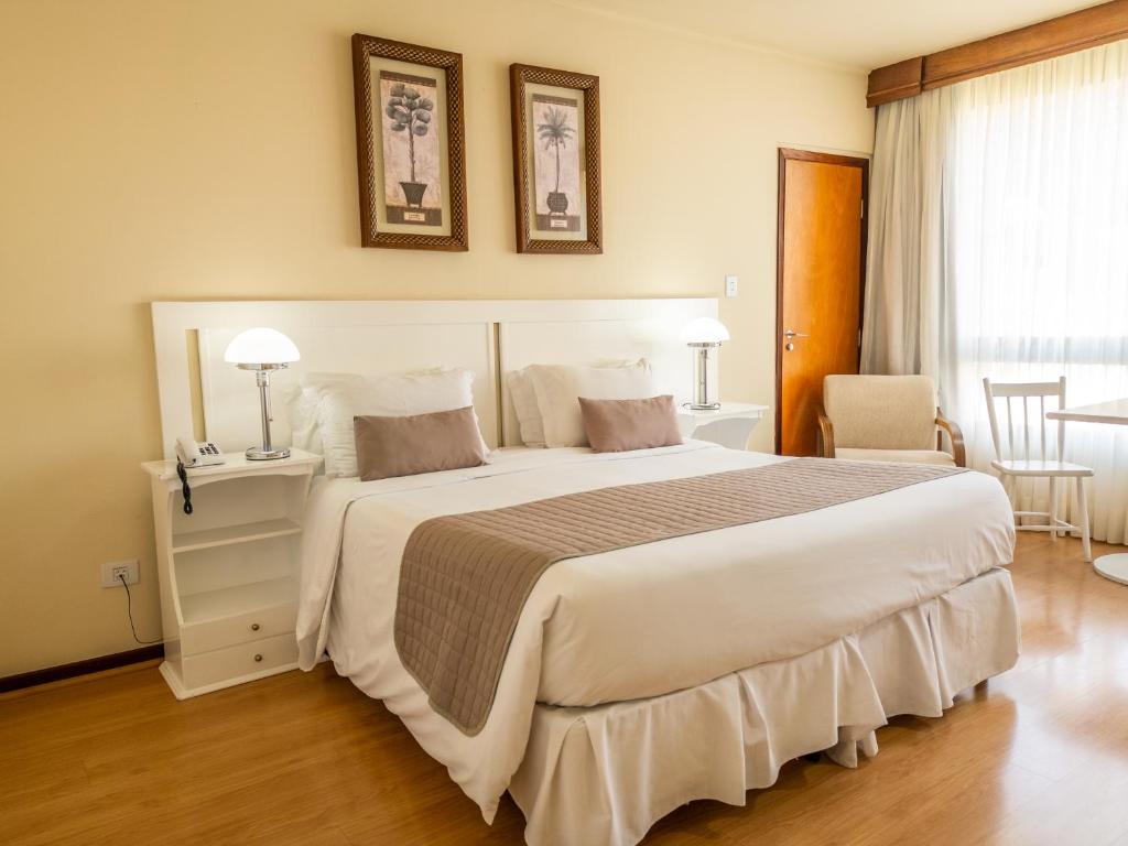 Postel nebo postele na pokoji v ubytování Radio Hotel Resort & Convention
