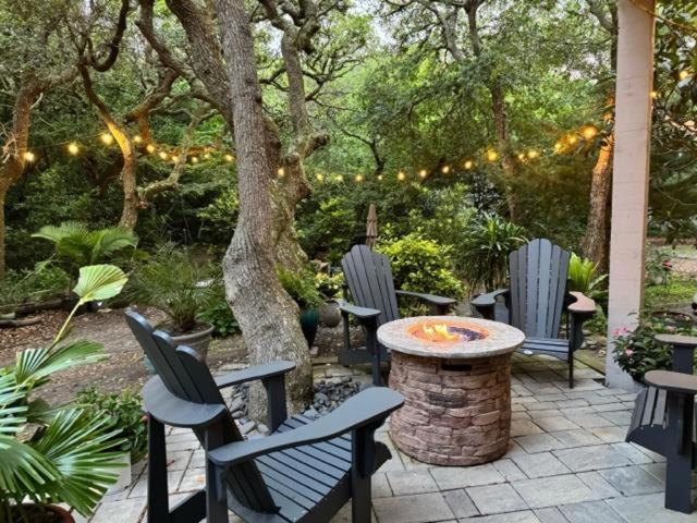 a patio with chairs and a table and a tree at Higher Altitude | Cozy Downstairs Apt. Close to the Beach in Surf City, NC in Sloop Point