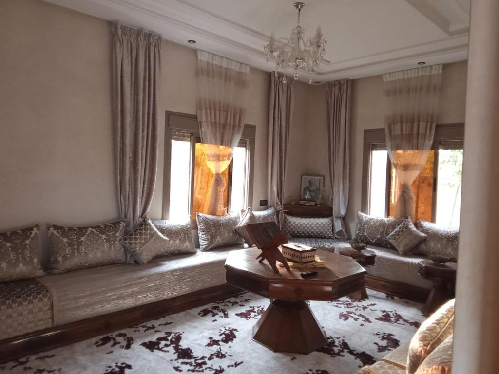 a living room with a couch and a table at Villa tagmouti in Aghmat