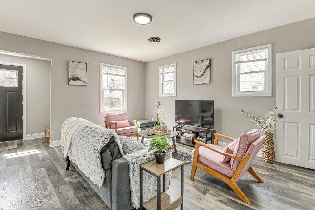 a living room with a couch and chairs and a tv at 4 Mi to Universities Quaint Parkville Apartment! in Parkville