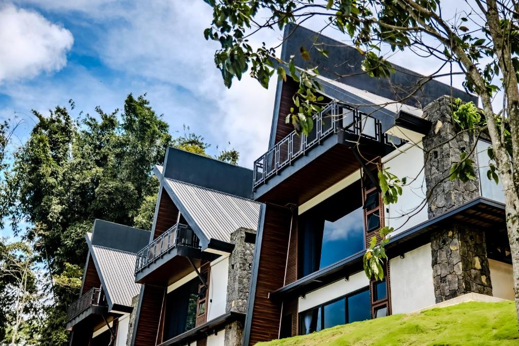 an exterior view of a house with balconies at Villa Bosque CR in Turrialba