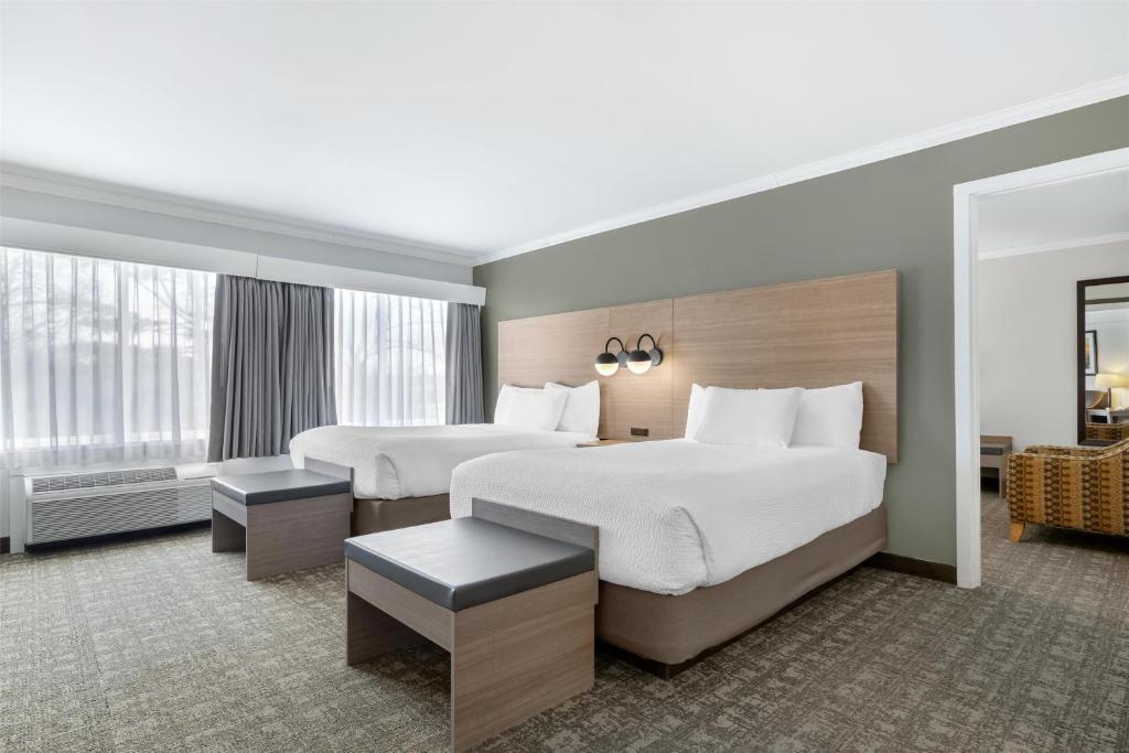 a hotel room with two beds and a large window at Best Western Plus Windjammer Inn & Conference Center in Burlington