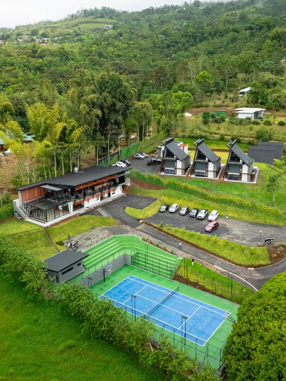 an aerial view of a tennis court and a house at Villa Bosque CR in Turrialba
