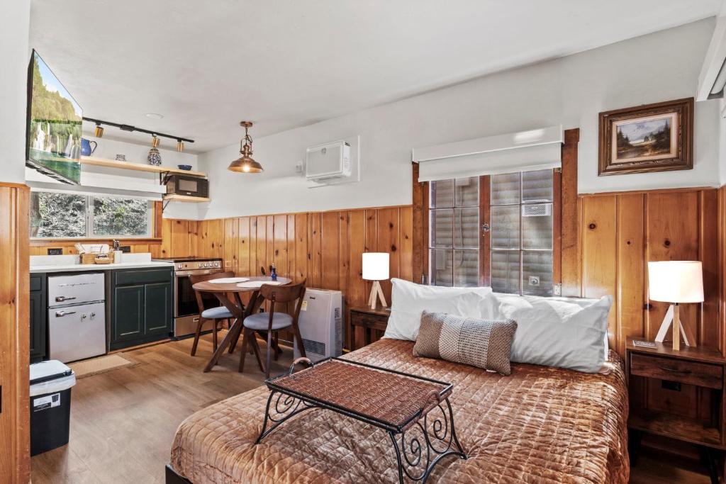 a bedroom with a bed and a kitchen with a table at Timber Lodge #11 in Colorado Springs