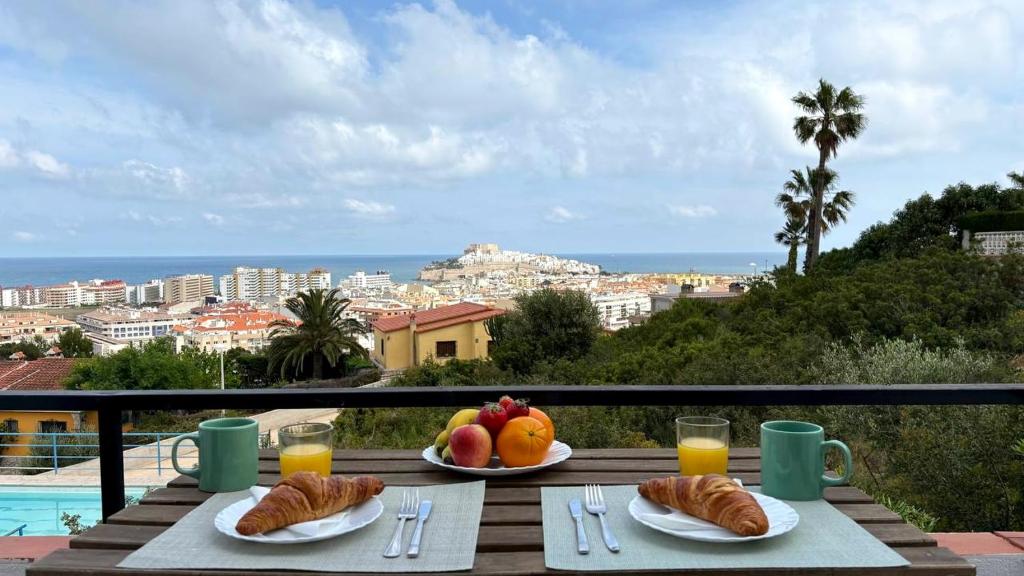 two plates of food on a table with a view of the ocean at Blu Mare apartment in Peniscola