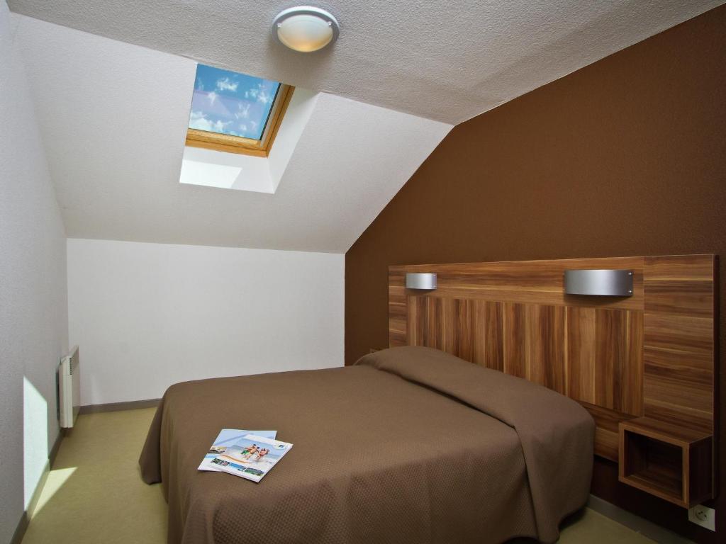 a small bedroom with a bed and a window at Chalet with shuttle bus in Gresse in Gresse-en-Vercors