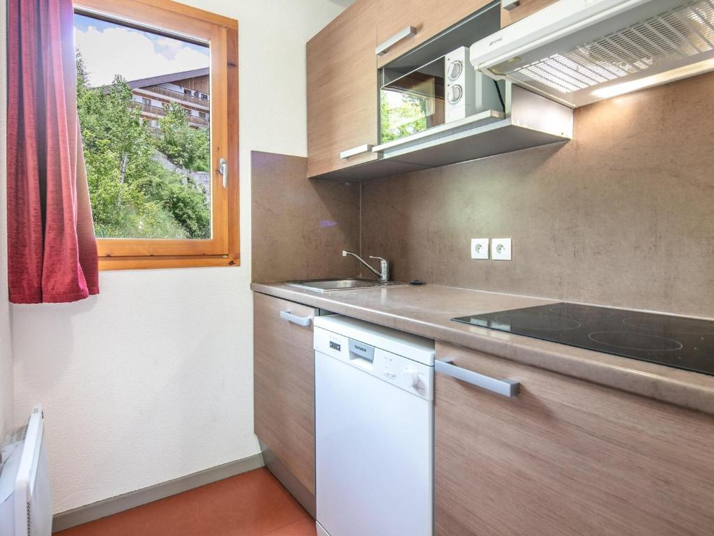 a small kitchen with a sink and a window at Chalet with shuttle bus in Gresse in Gresse-en-Vercors