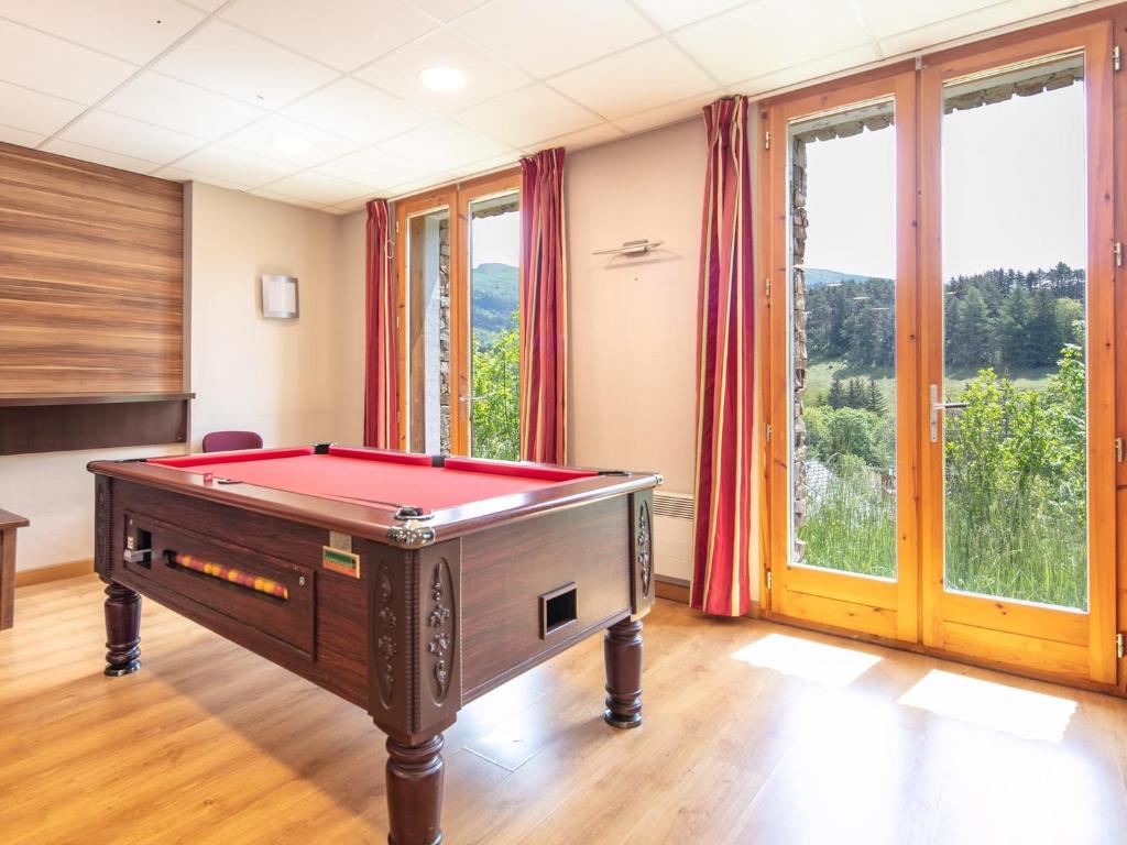 a room with a pool table in front of windows at Chalet with shuttle bus in Gresse in Gresse-en-Vercors