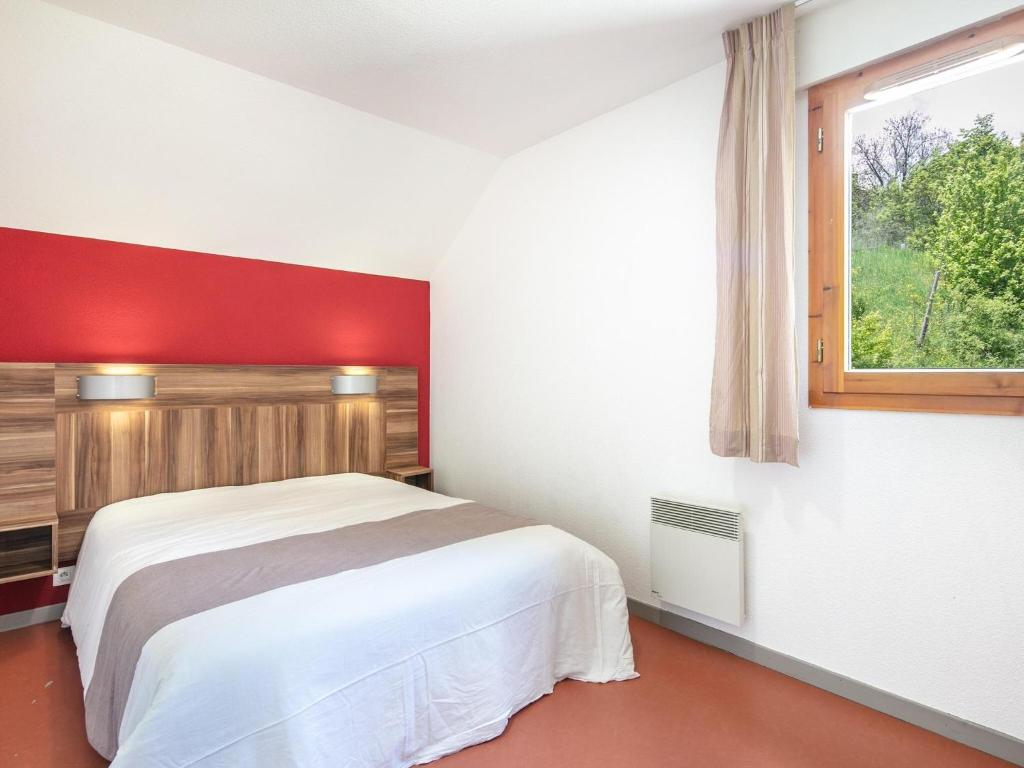 a bedroom with a white bed and a window at Chalet with shuttle bus in Gresse in Gresse-en-Vercors