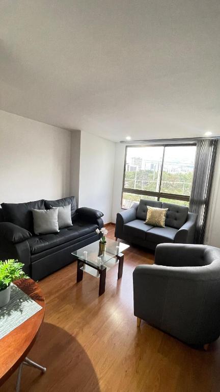 a living room with two couches and a table at Aparta estudio muy bien ubicado in Medellín