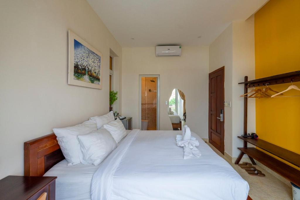 Postel nebo postele na pokoji v ubytování Green Town House Hoi An