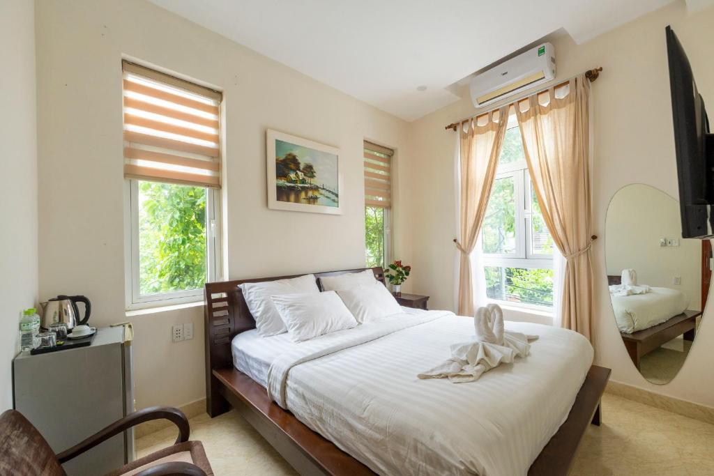 Postel nebo postele na pokoji v ubytování Green Town House Hoi An