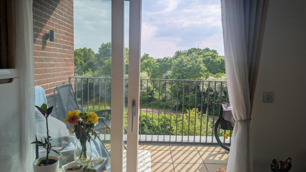 a view of a balcony with a table with flowers on it at Luxury living- colindale garden -Double room in Colindale