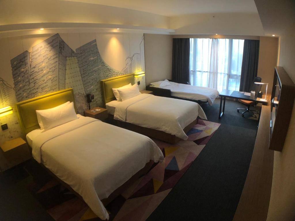 Postel nebo postele na pokoji v ubytování Hampton by Hilton Guangzhou Jinshazhou
