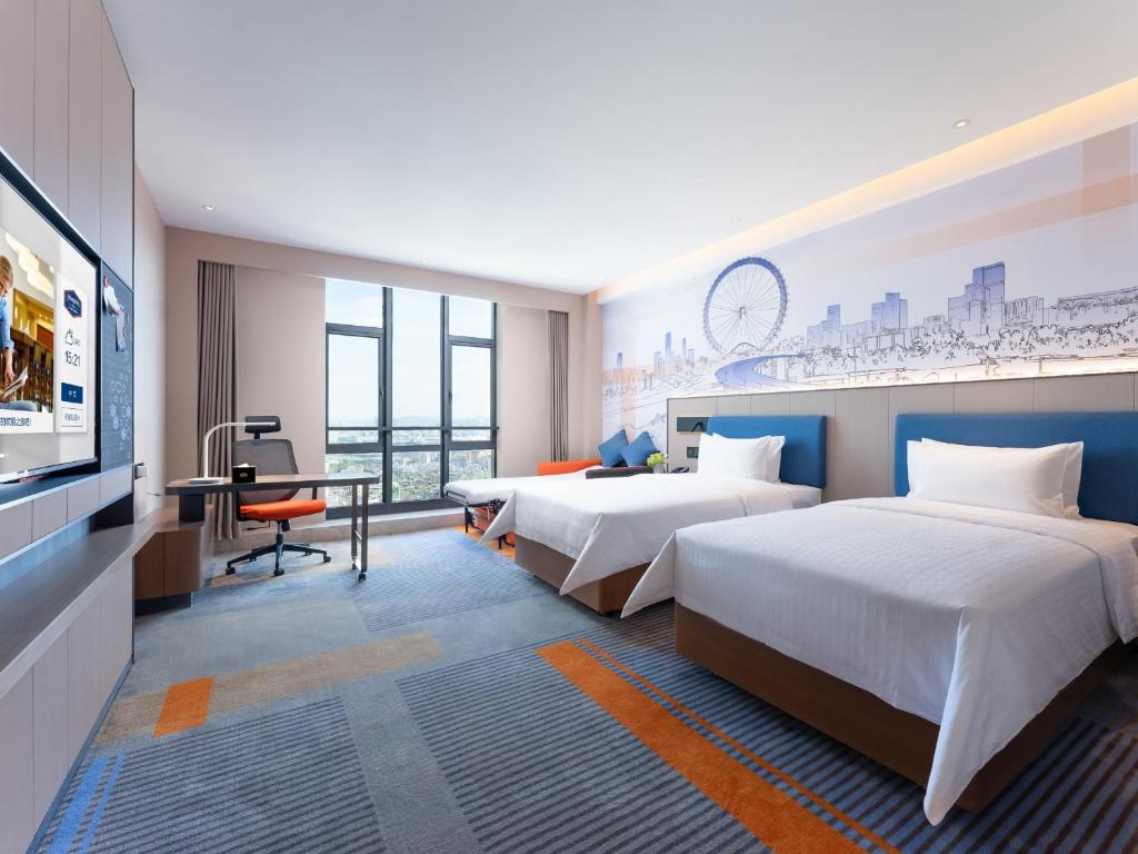 Postel nebo postele na pokoji v ubytování Hampton by Hilton Guangzhou Jinshazhou