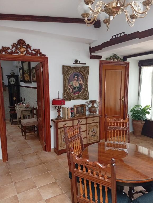 Un comedor con mesa y sillas de madera. en Casa Rural en San Carlos del Valle- Doña Gumersinda, en San Carlos del Valle
