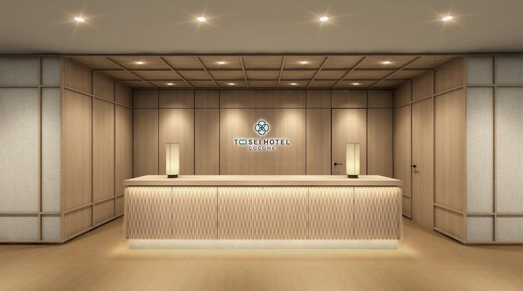 a hotel lobby with a reception counter and a logo at Tosei Hotel Cocone Kamata in Tokyo