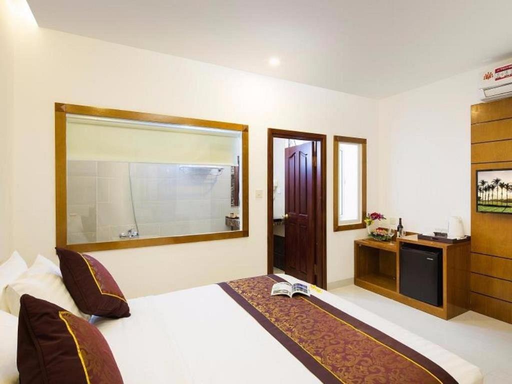 Postel nebo postele na pokoji v ubytování Sunniva Hotel Nha Trang
