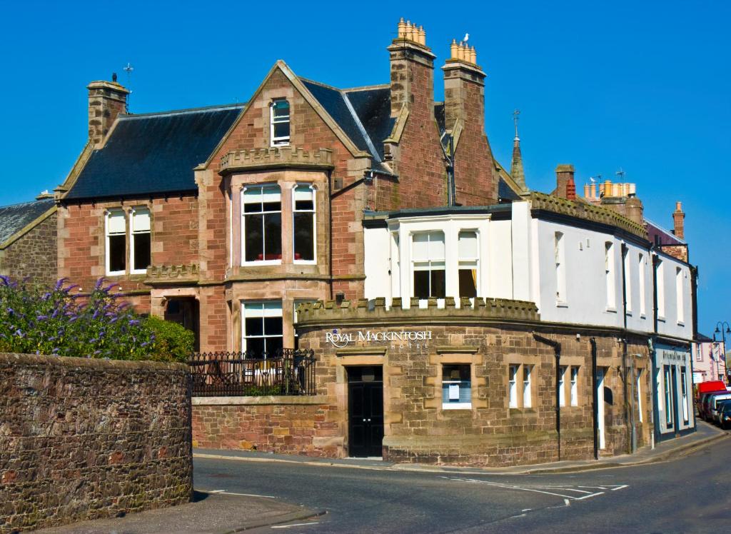 an old brick building on the side of a street at Royal Mackintosh Hotel in Dunbar