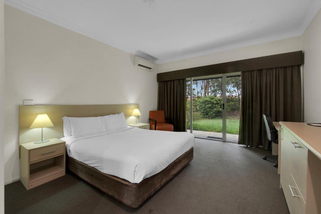 Postel nebo postele na pokoji v ubytování Hunter Gateway Motel
