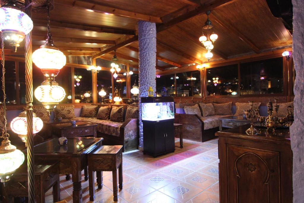 a large room with couches and a television in it at Résidence Hoteliére Chez Aziz in Chefchaouene