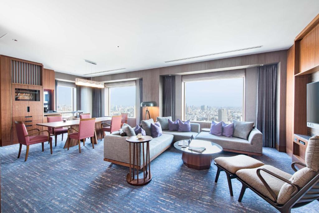 a living room with a couch and chairs and tables at Cerulean Tower Tokyu Hotel, A Pan Pacific Partner Hotel in Tokyo