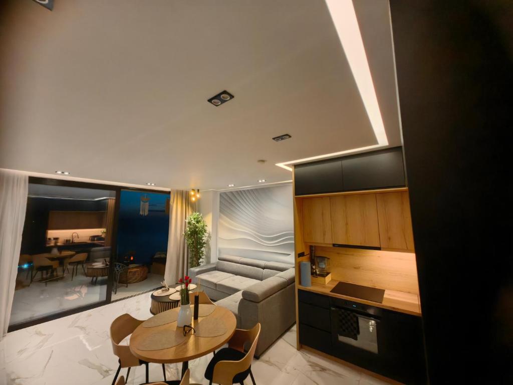 a living room with a couch and a table at Luxury Panorama View with a Pool in Sarandë