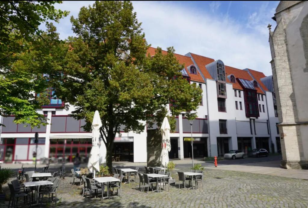 a group of tables and chairs in front of a building at Premium maisonette in city center with parking in Braunschweig