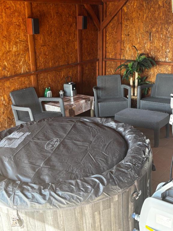 a room with a table and chairs and a largelatablelatable at Sunny Faház in Poroszló