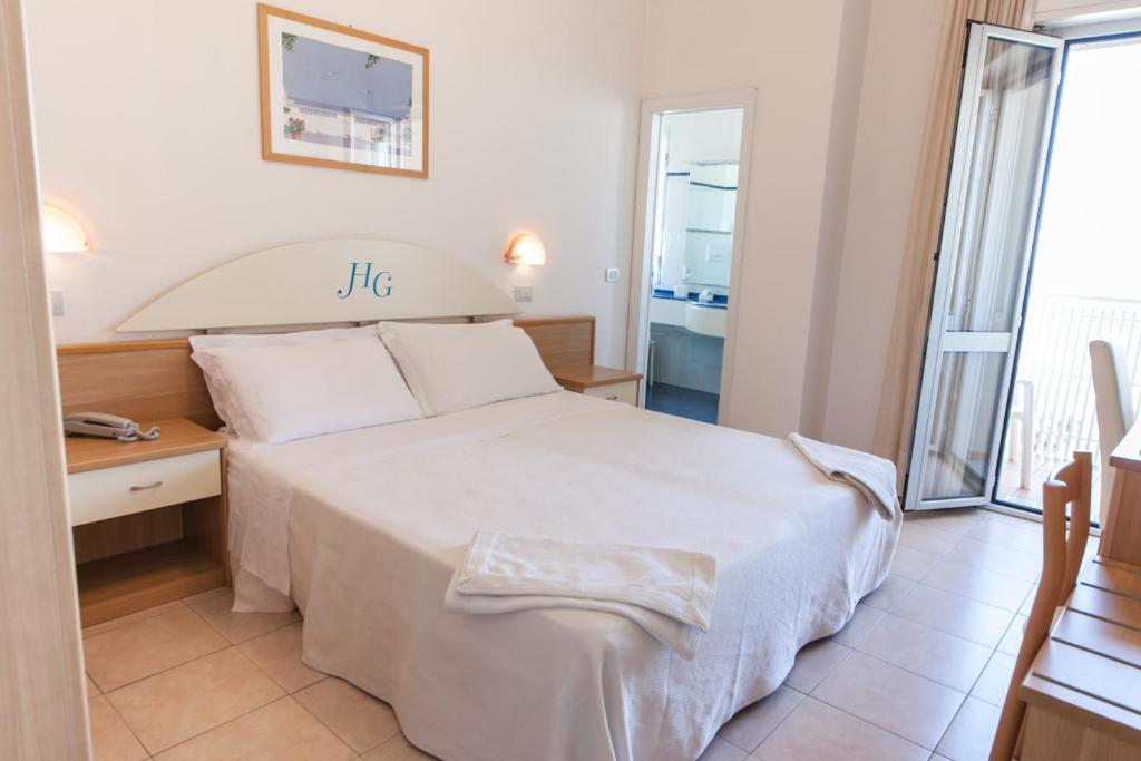 Postel nebo postele na pokoji v ubytování Hotel Gabbiano
