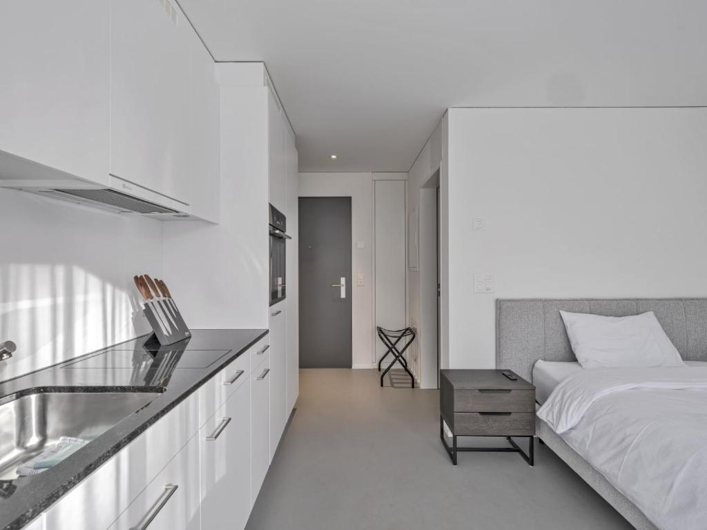 Postel nebo postele na pokoji v ubytování MOOI Apartments Grenchen