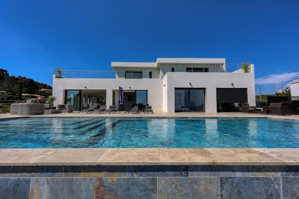 a house with a swimming pool in front of a house at Bella Vista Cotignac - Piscine Privée in Cotignac