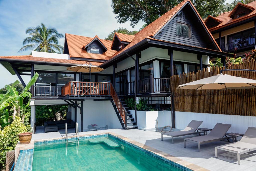 a villa with a swimming pool and a house at Baan Fah Sai in Koh Phangan