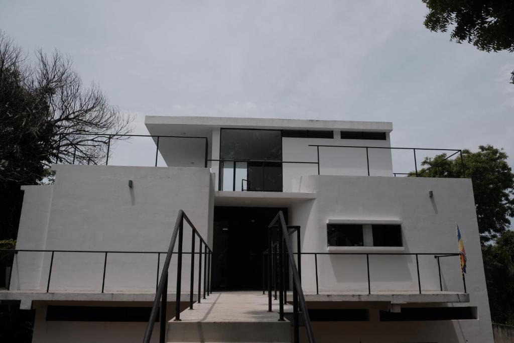a white building with a staircase in front of it at Kadurupokuna villa Tangalle in Tangalle