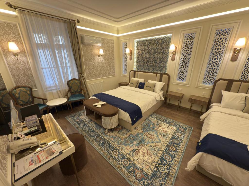 a bedroom with a bed and a table and a couch at Oasis Inn Budapest in Budapest