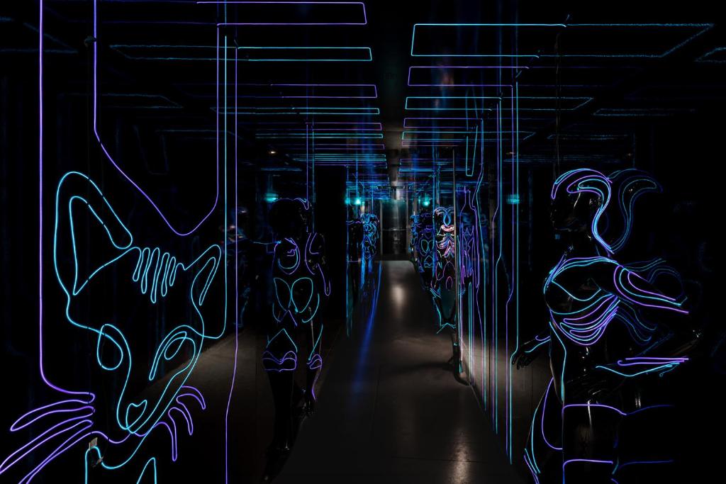 a dark room with blue lights on the walls at FIVE Zurich - Luxury City Resort in Zürich