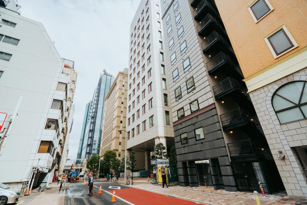 a street in a city with tall buildings at Hotel LiVEMAX Shiodome in Tokyo