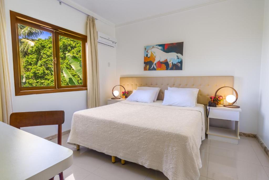 Postel nebo postele na pokoji v ubytování Enseada dos Corais Praia Hotel
