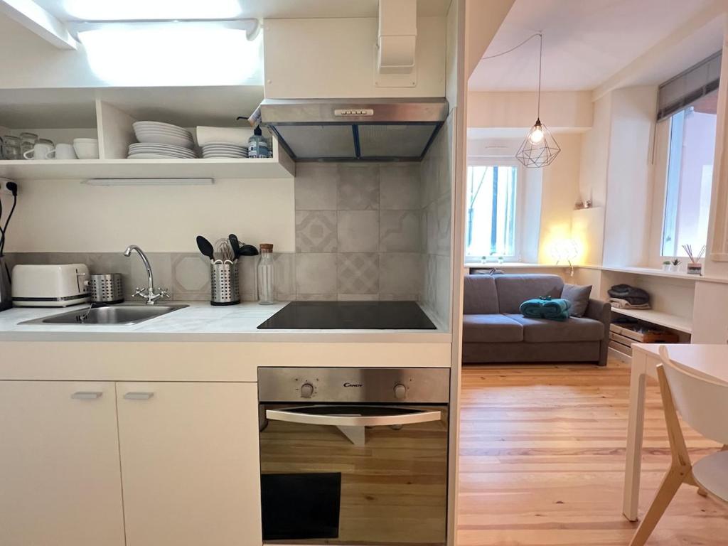 une cuisine avec un évier et une cuisinière four supérieur dans l'établissement Studio plein centre, à Cauterets