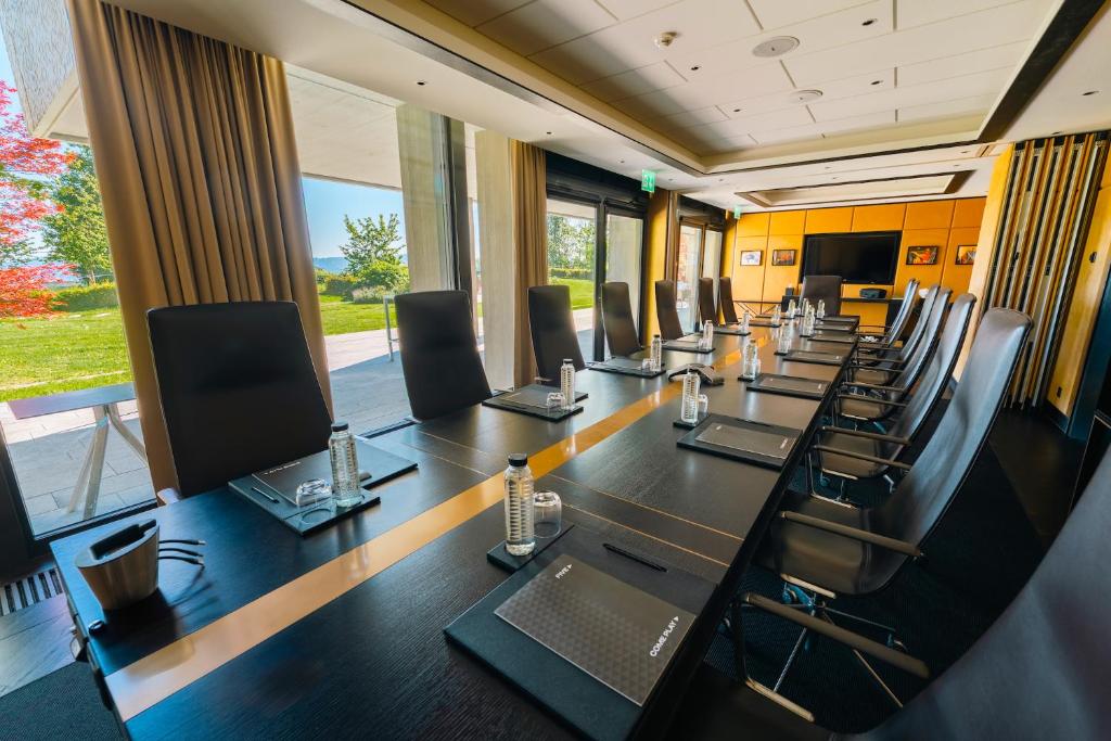 a conference room with a long table and chairs at FIVE Zurich - Luxury City Resort in Zürich