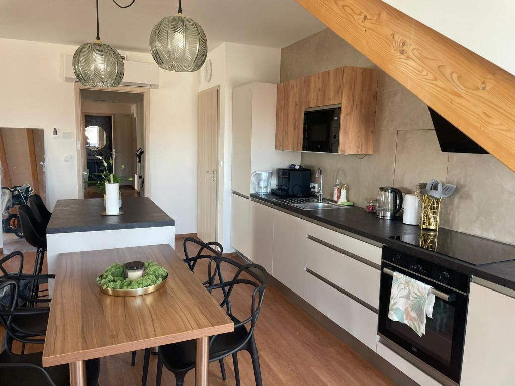 a kitchen with a table and a counter top at NOSTALGIE BOUTIQUE Suite in Brno