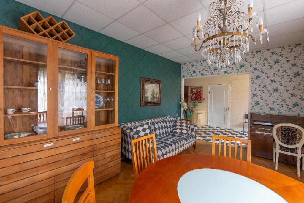 a living room with a table and a couch at Baltic Holiday Guest House in Jūrmala