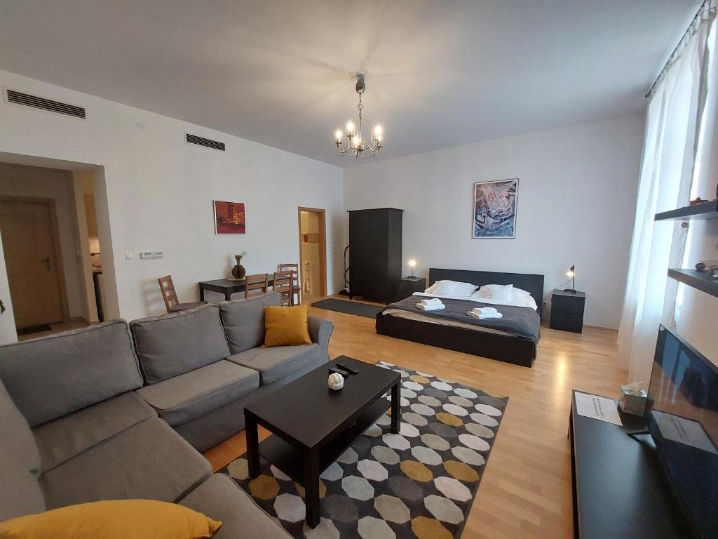 ein Wohnzimmer mit Sofa und Bett in der Unterkunft Lakeside Heritage Apartment in Balatonfüred